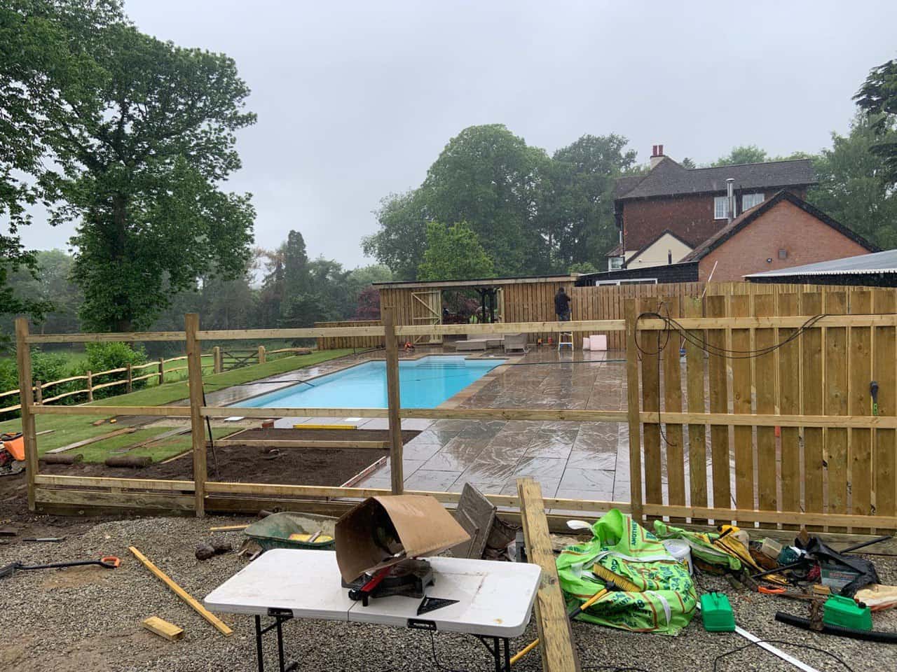 This is a photo of Bespoke custom fencing installed around a swimming pool by Fast Fix Fencing Sutton