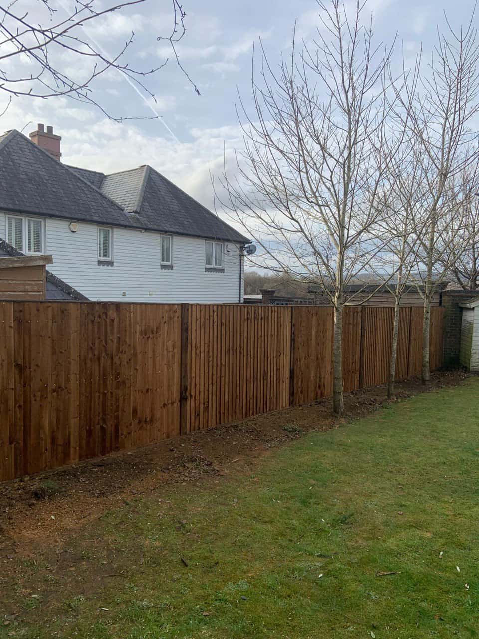 This is a photo of feather edge fencing installed in a residential properties garden by Fast Fix Fencing Sutton
