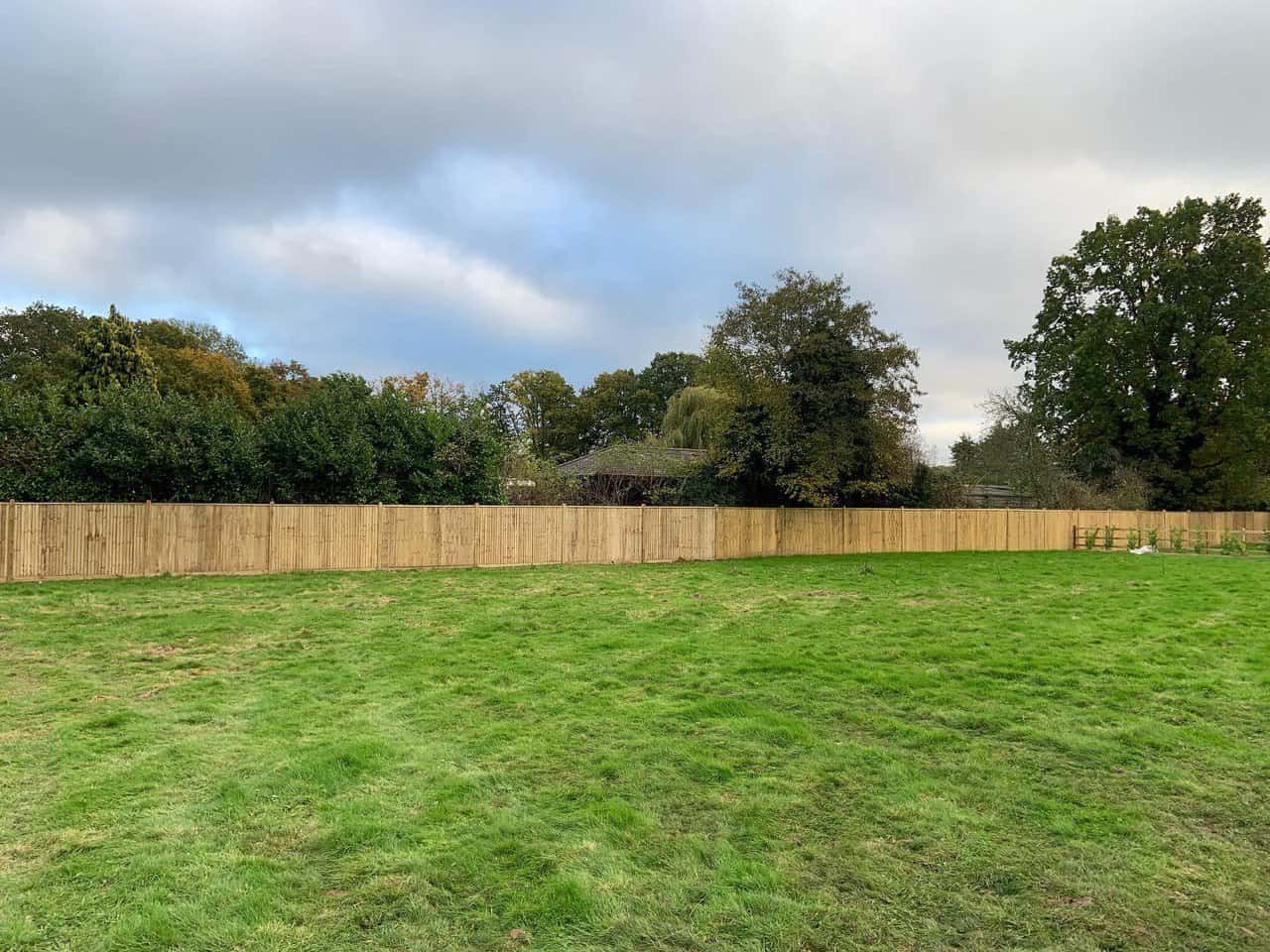 This is a photo of feather edge fencing installed around the edge of a field by Fast Fix Fencing Sutton